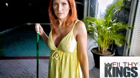 Redhead MILF teasing big natural tits in skimpy yellow dress by pool at night