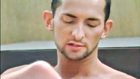Handsome bearded gay hunk with eyes closed in ecstasy bare chest in steamy sauna