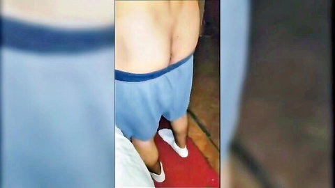Muscular man pulls down blue shorts exposing bare ass cheeks and crack.