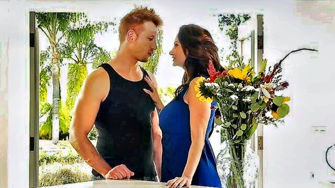 Ava Addams in blue dress sharing intimate moment with muscular redhead stud and flowers