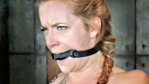 Gagged redhead with braided hair in intense BDSM subspace punishment