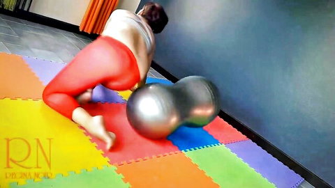 Skinny brunette MILF in tight red leggings arches ass high in doggy yoga pose on gym mat