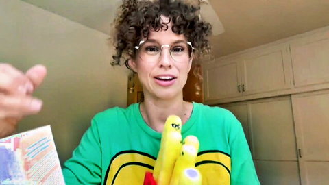VibeWithMommy as playful stepmom in green banana shirt holding plush toys