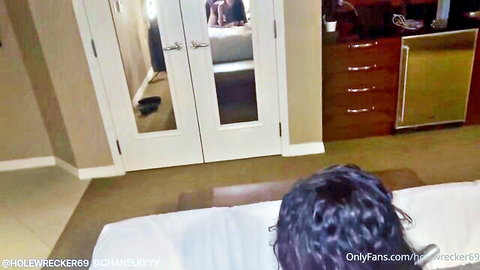 Chanelkeyy lying face down on bed, curly hair tease from OnlyFans