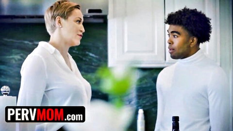 Short-haired blonde MILF in white blouse stares seductively at young black stud in kitchen on PerVMom