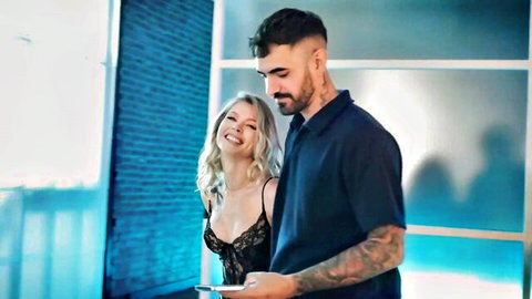 Jax Slayher with smiling blonde in black lace lingerie
