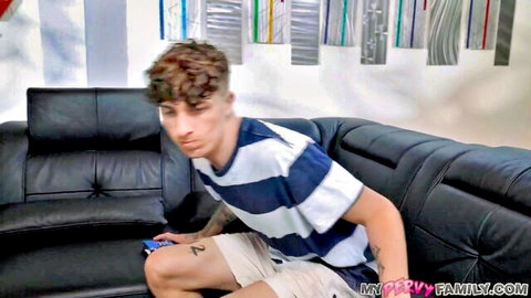 Ethan Seeks lounging casually on couch, seeking Naudi Nala's pleasures