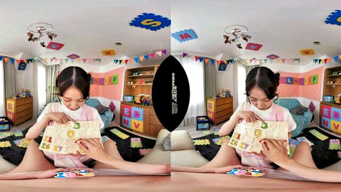 Petite Asian girl in pink dress playing with toys in nursery room