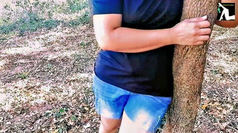 Chubby South Asian babe in tight blue shorts hugs tree in jungle teasing juicy ass cheeks