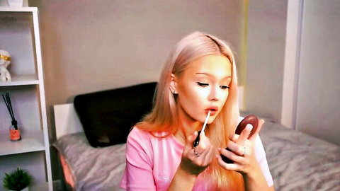 Sexy blonde babe puckering lips applying red lipstick in teasing webcam solo