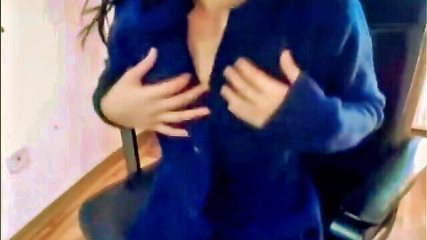 Brunette with big tits teases deep cleavage pulling open blue robe on chair
