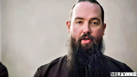 Bearded man with man bun and thick beard speaking on camera for MILF porn site