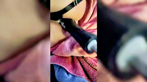 Blurry close-up of amateur woman with black collar using black dildo toy near mouth