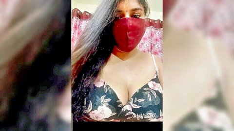 Busty Indian wife teases huge tits in floral bra with red face mask