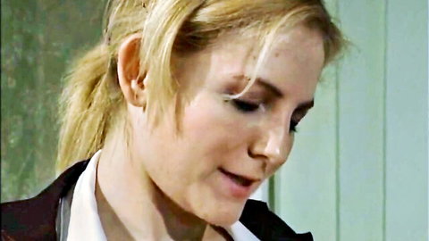 Blonde office babe in suit smirking seductively with parted lips