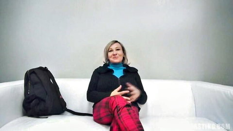 Amateur mommy with huge boobs sitting casually on couch smiling