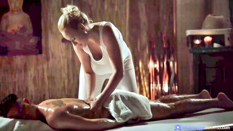 Blonde masseuse with big boobs giving erotic massage to tattooed man