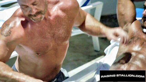 Hairy muscular men in steamy poolside touch at Love Trans Sex