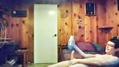 Slim naked Asian twink with glasses holding blue bottle solo