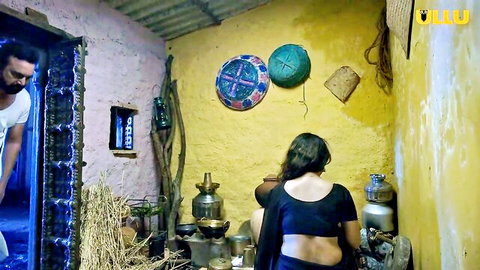 Desi village girl in backless black blouse bending over, spied by man in rustic kitchen