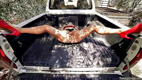Nude blonde in red heels spreads legs wide in truck bed outdoors