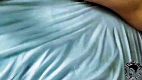 Closeup of sexy pale ass cheek draped in wrinkled blue sheet teasing