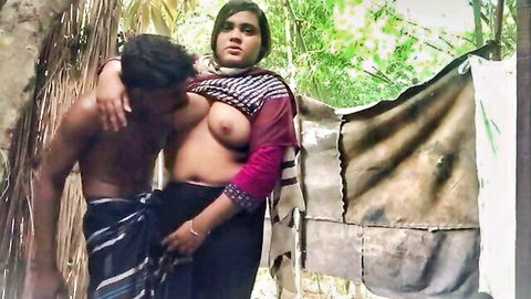 Busty Indian housewife with exposed tits hugged tightly by muscular man outdoors on farm