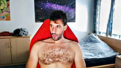 Hairy bearded man sitting shirtless in chair, amateur gay porn thumbnail