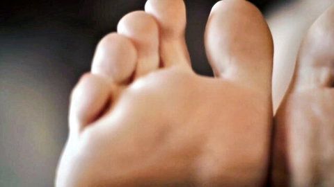 Close-up of sexy bare feet soles and toes spread for foot worship fetish