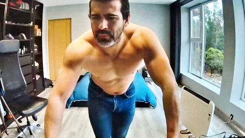 Muscular Latino hunk posing shirtless in jeans