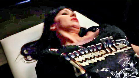 Brunette rocker in shiny Iron Maiden shirt gagging on thick black dildo with neck stretched back