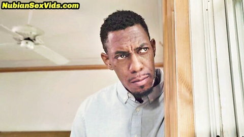 Black man peeking through door in teasing bedroom encounter