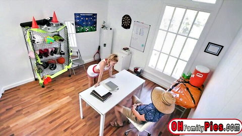Blonde teen in short dress bends over desk without panties, teasing seated man