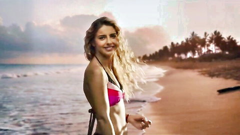 Michelle Renaud in pink bikini on sunny beach, Corazonada (2022) strip scene tease