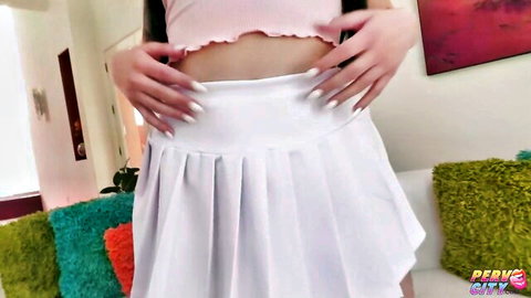 Scarlett Rosewood teases in pink crop top and white pleated skirt