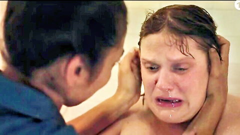 Distressed wet topless girl crying profusely as Asian woman grips her face in bathtub