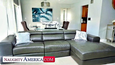 Empty luxurious gray leather L-shaped couch in modern living room from Naughty America
