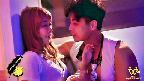 Sexy Asian redhead in low-cut top intimately embracing muscular guy in neon club tease