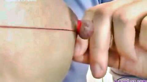 Japanese girl in intense nipple thread torture, close-up BDSM play