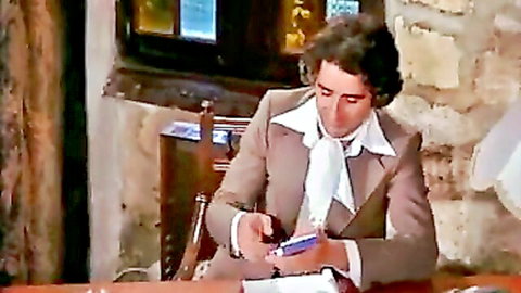 Vintage 1976 adult film scene with suited man in formal attire