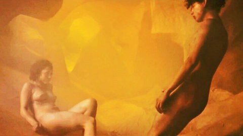 Nude woman sits legs spread exposing shaved pussy as nude man stands with erect cock visible in surreal orange fantasy scene