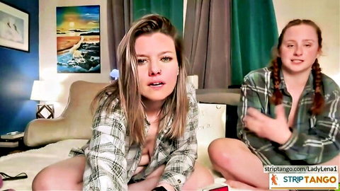 Blonde and redhead lesbians in open plaid shirts on Stripchat webcam