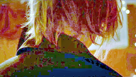 Blonde woman viewed from behind, exposing neck in green top