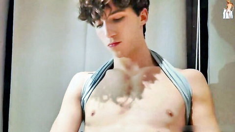 Curly-haired twink in gray harness, shirtless amateur gay pose