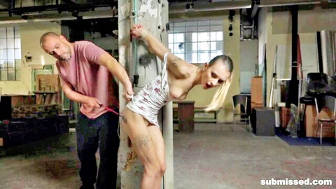 Adelle Unicorn submissive blonde bent over exposed in dress with man behind