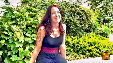 Luciolle, tattooed redhead MILF smiling in garden, busty and seductive