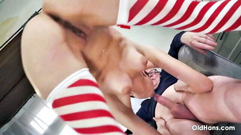 Alyssa Bounty topless in striped sleeves, close to older man's erect penis for blowjob