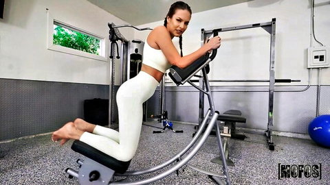 Ally Wild in tight white leggings seductive gym bend-over pose