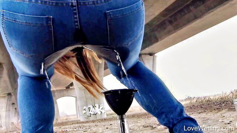 Jessica Bell peeing into jerry can through ripped jeans outdoors