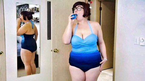 Curvy chubby MILF in blue swimsuit posing erotically in mirror